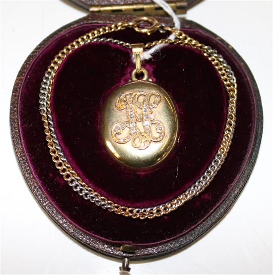 A Russian 14K gold oval locket with diamond set initial H, on a two-colour gold curb-link chain(-)